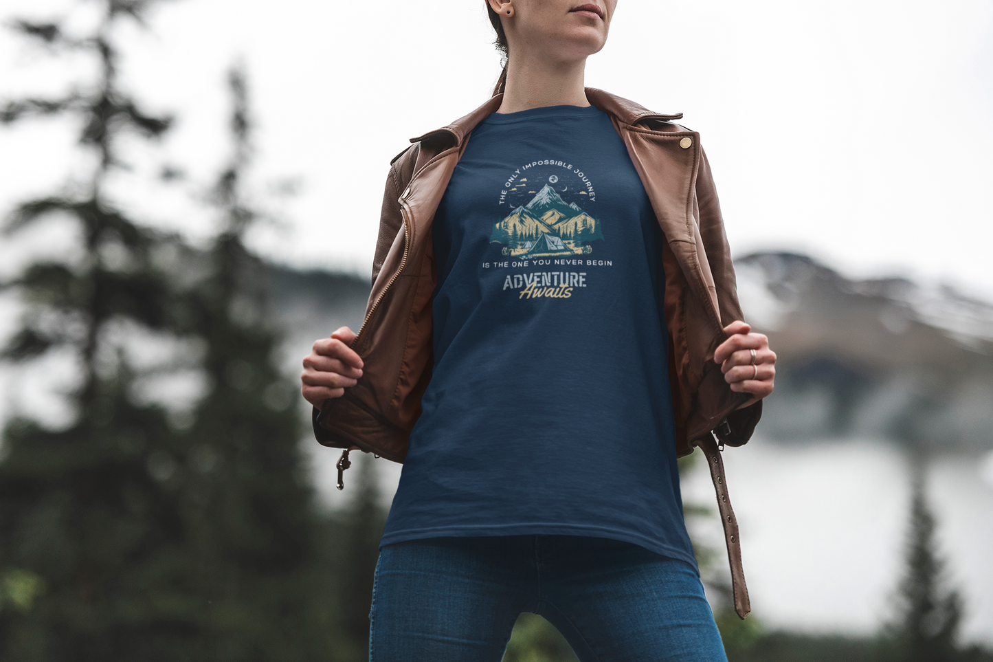 Person wearing a blue t-shirt with a mountain design outdoors