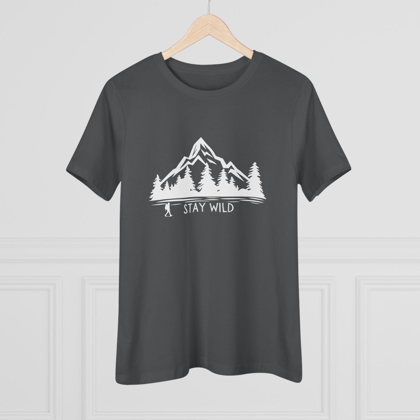 Dark gray t-shirt with a white mountain and tree graphic and 'Stay Wild' text on a light gray background.